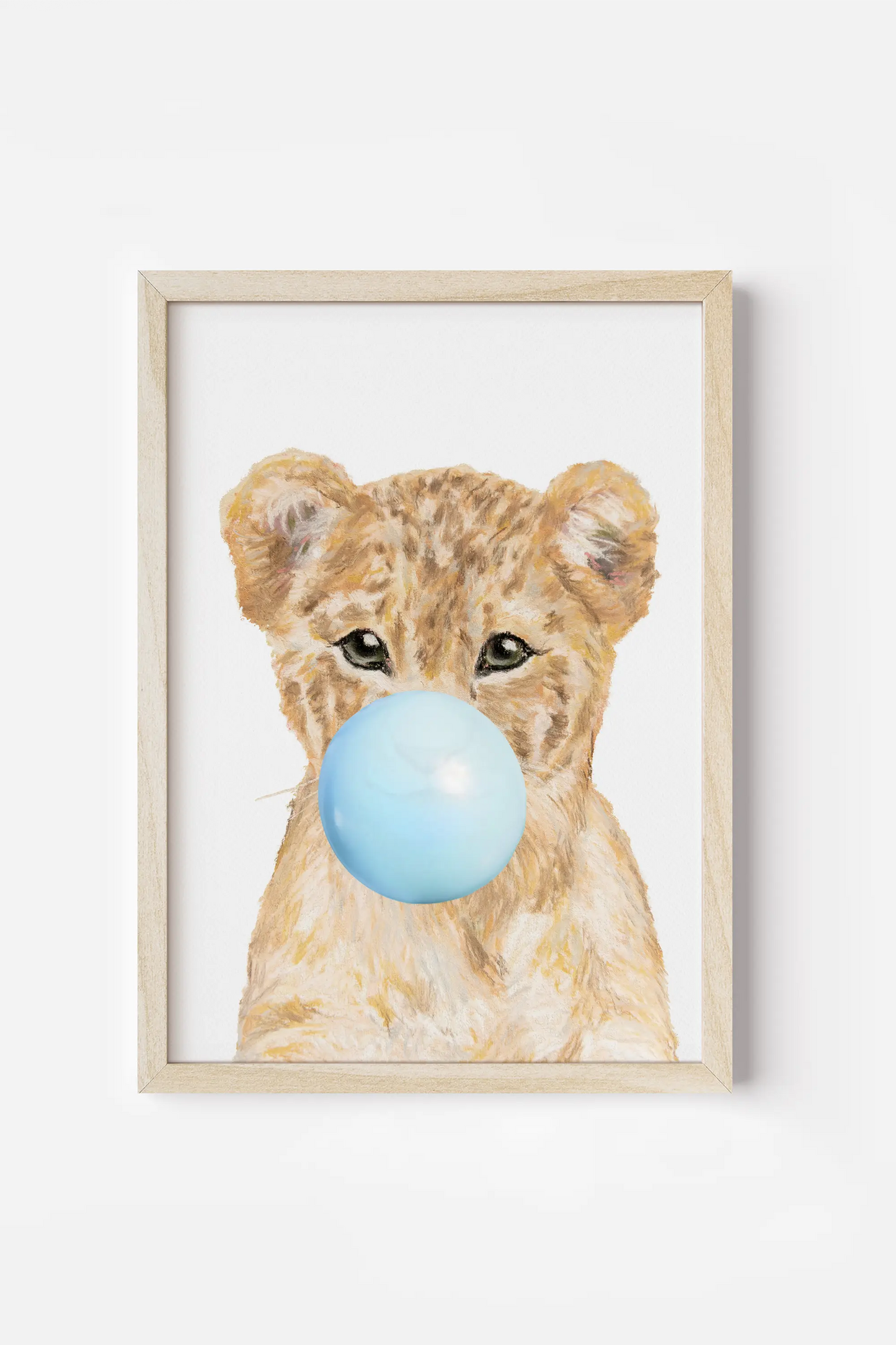 a picture of a baby bear with a blue ball in its mouth