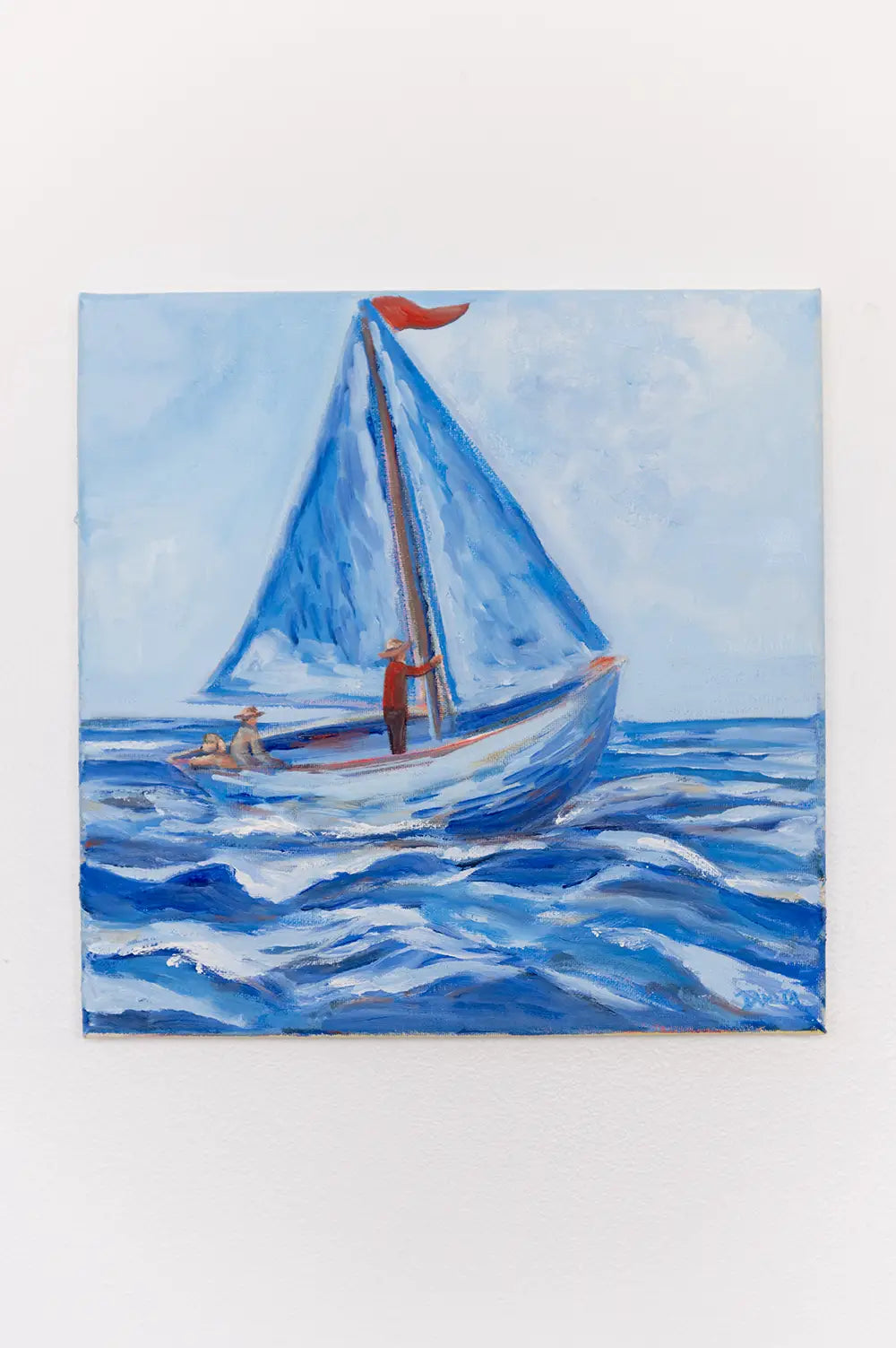 Along for the Ride displayed on a white wall, featuring a blue sailboat carrying 2 figures and dog across the ocean.