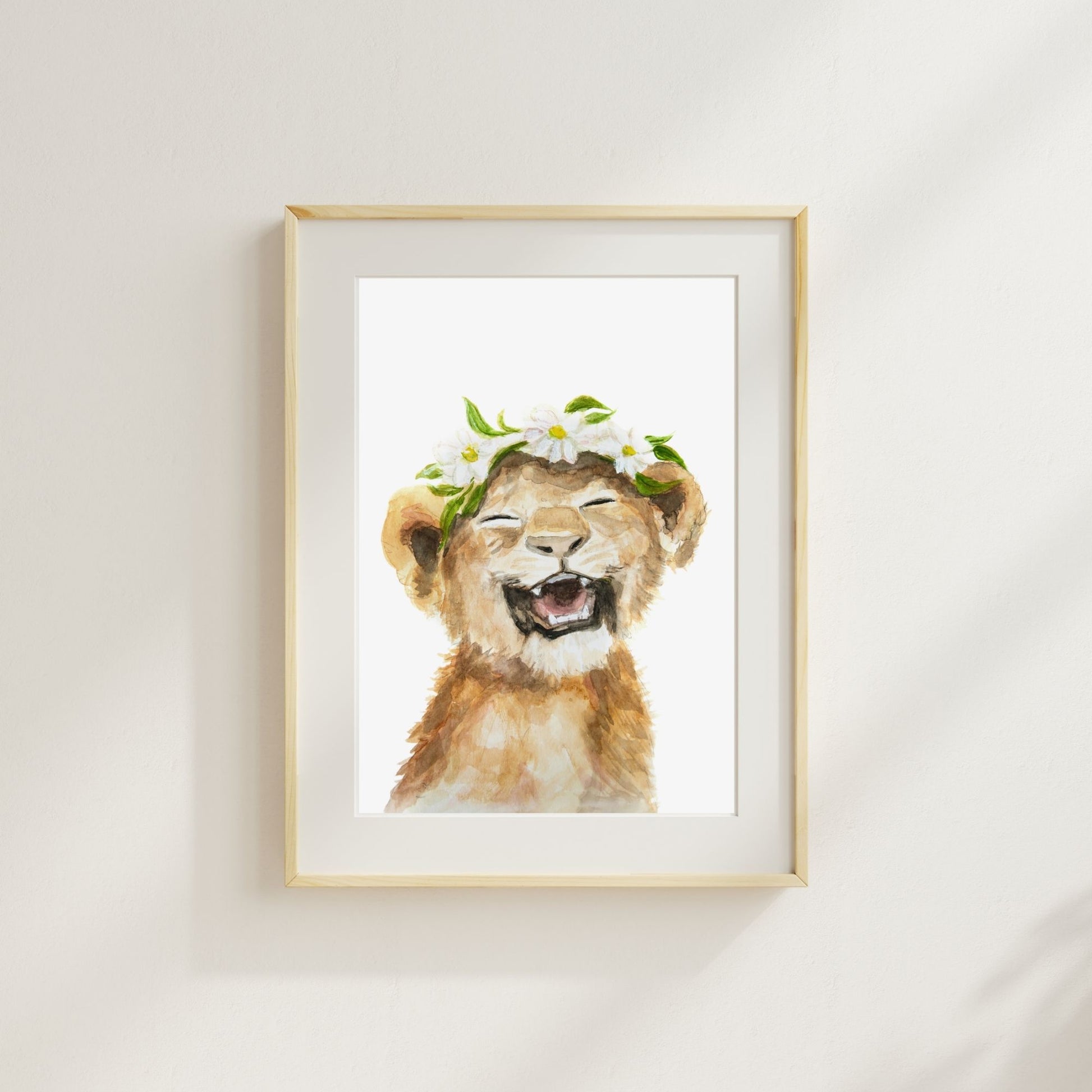 Watercolor lion cub print with floral crown styled in children’s room – jungle nursery decor