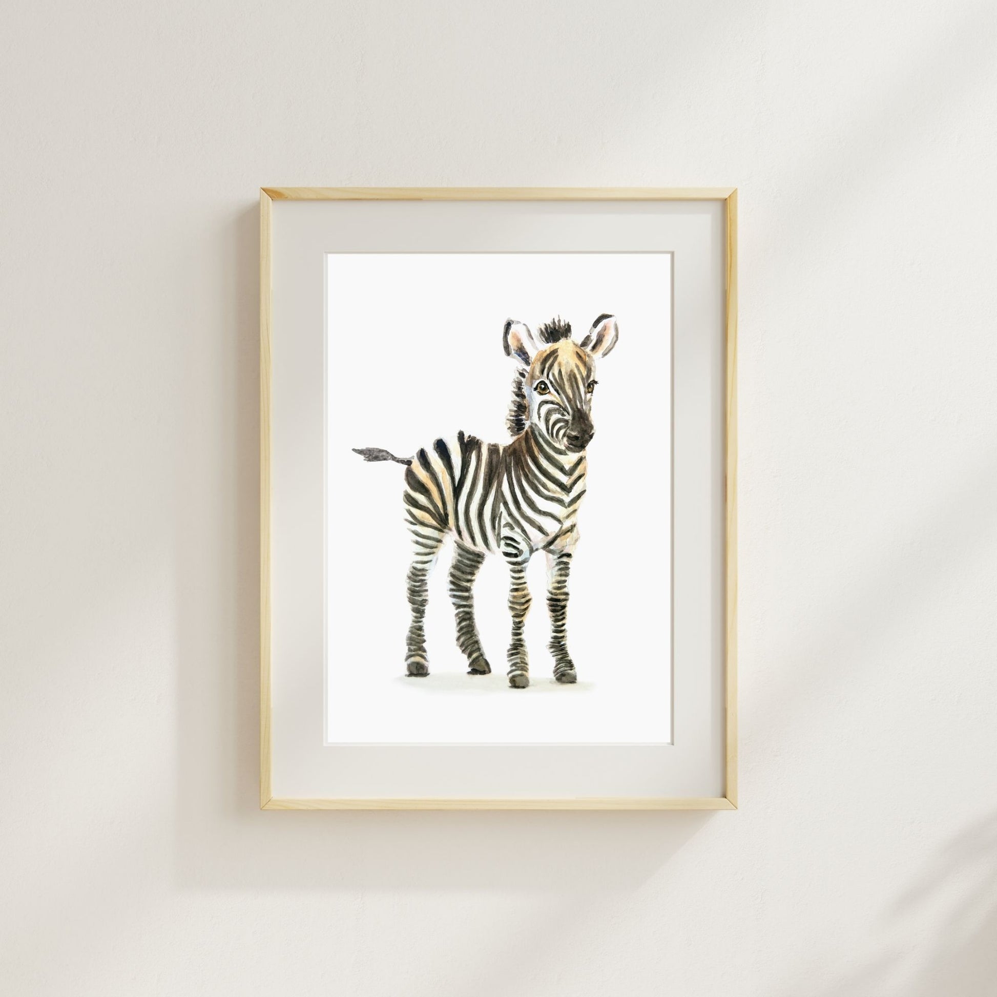 Safari-themed nursery with framed zebra print – neutral jungle baby room decor