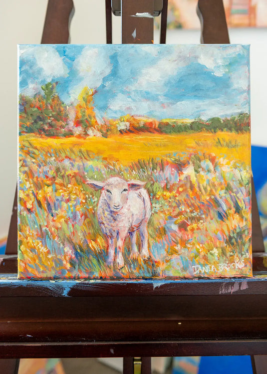 Front view of “Beloved” original lamb painting by Danita Brooks, displayed on Danita's painting easel