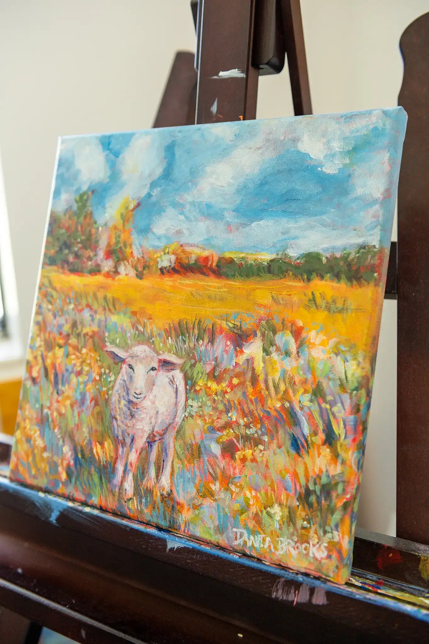 Angled view of framed “Beloved” lamb artwork, highlighting texture and hand-painted details