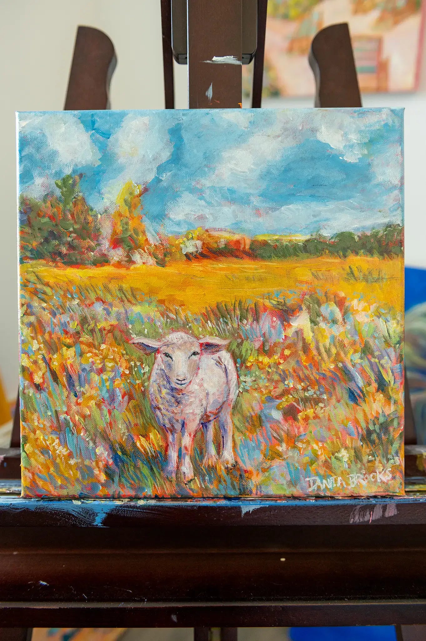 Front view of “Beloved” original lamb painting by Danita Brooks, shown in the studio on the artist easel