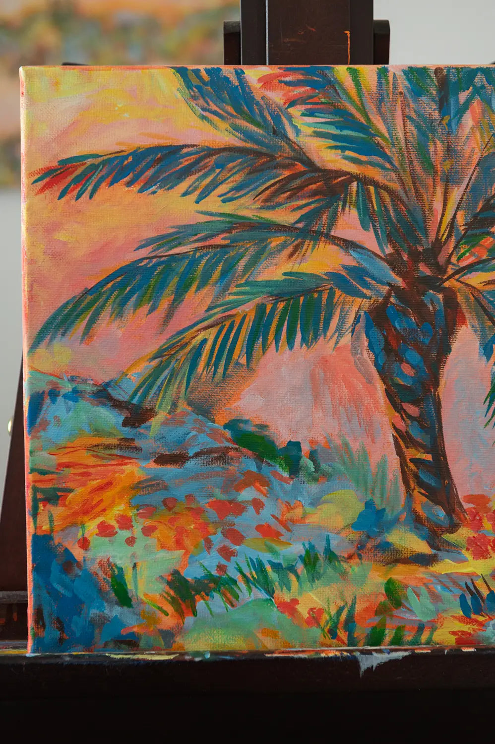 Close-up of palm tree silhouette and vivid sunset hues in the acrylic painting "Sorbet Skies"
