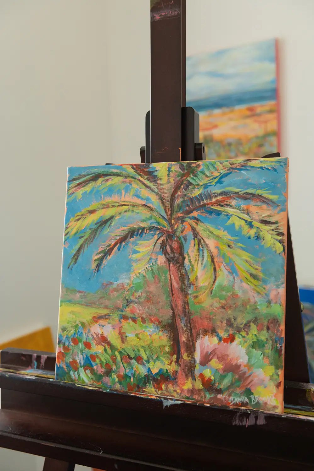 Coastal painting "Midday Blues" by Danita Brooks, angled to show the soft brushwork and uplifting sky palette