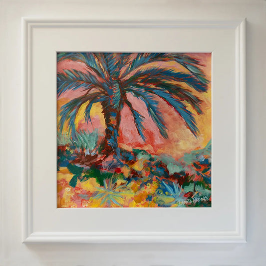 Original palm tree painting titled "Everlasting Sunset" by Danita Brooks, framed in white plein air frame and displayed in natural light