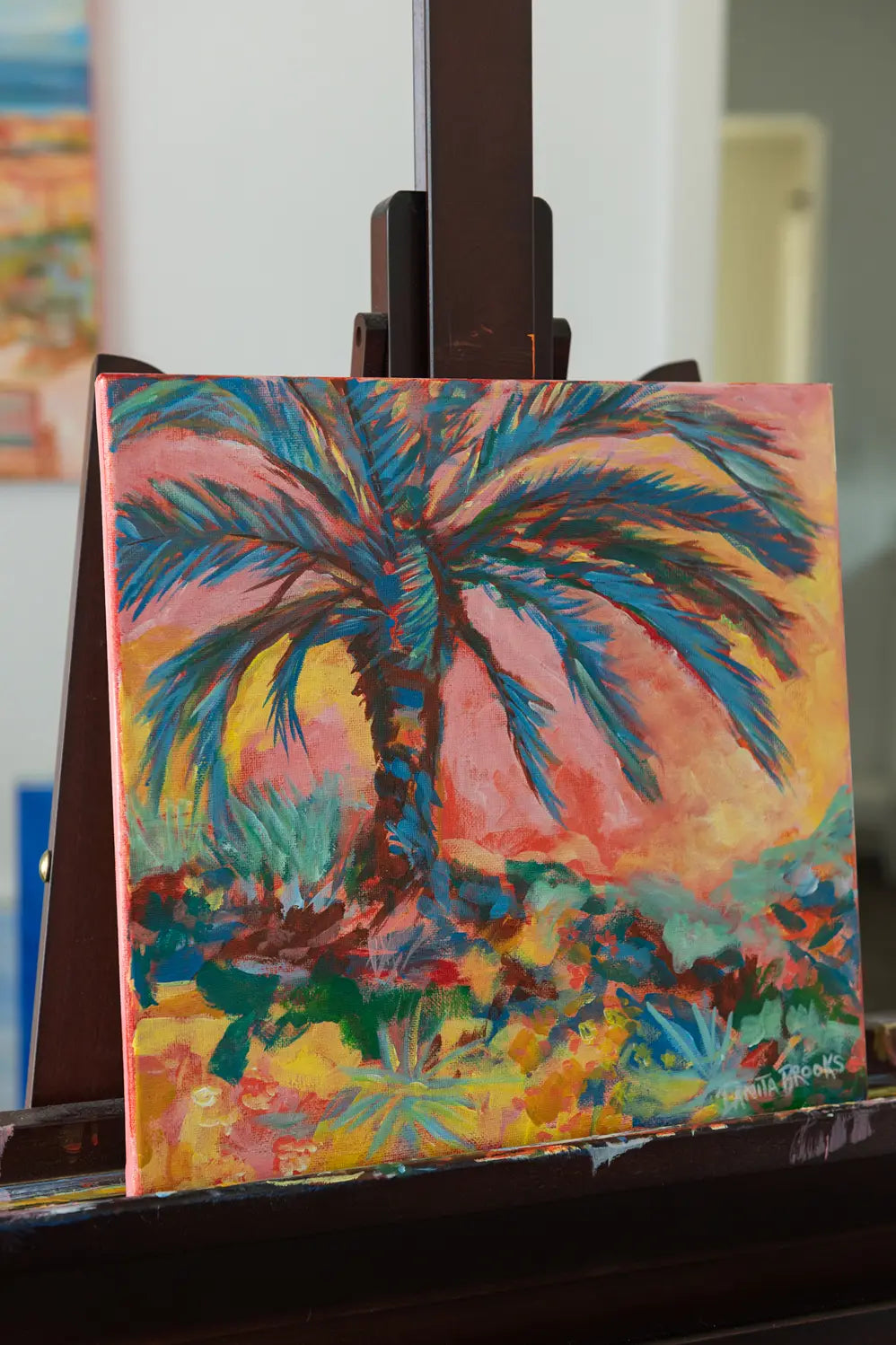 Side view of "Everlasting Sunset" framed acrylic painting showing the silhouette of a palm tree against a colorful sunset sky
