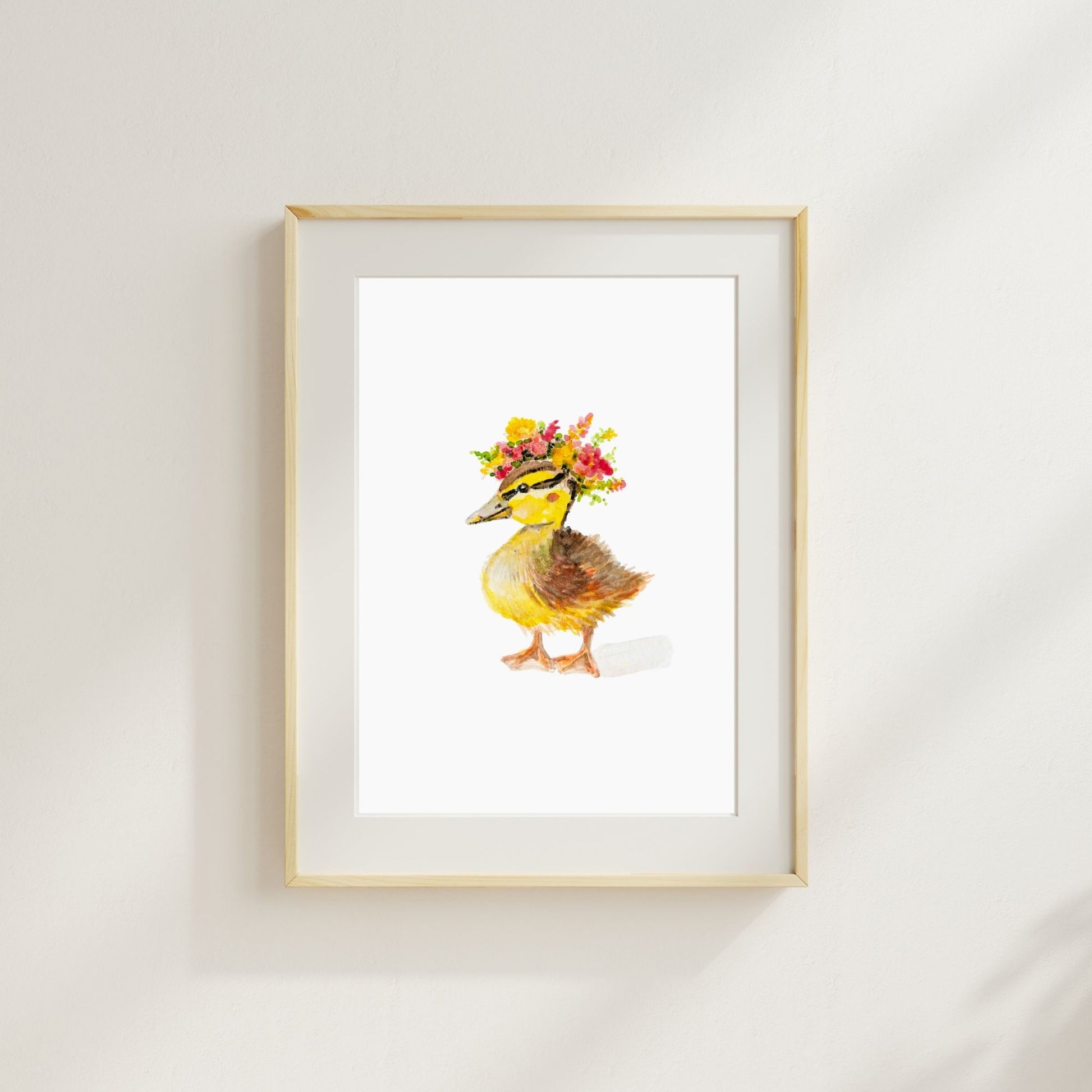 Farm nursery watercolor duck print – whimsical floral duckling decor for baby’s room here shown in a wood frame with a mat