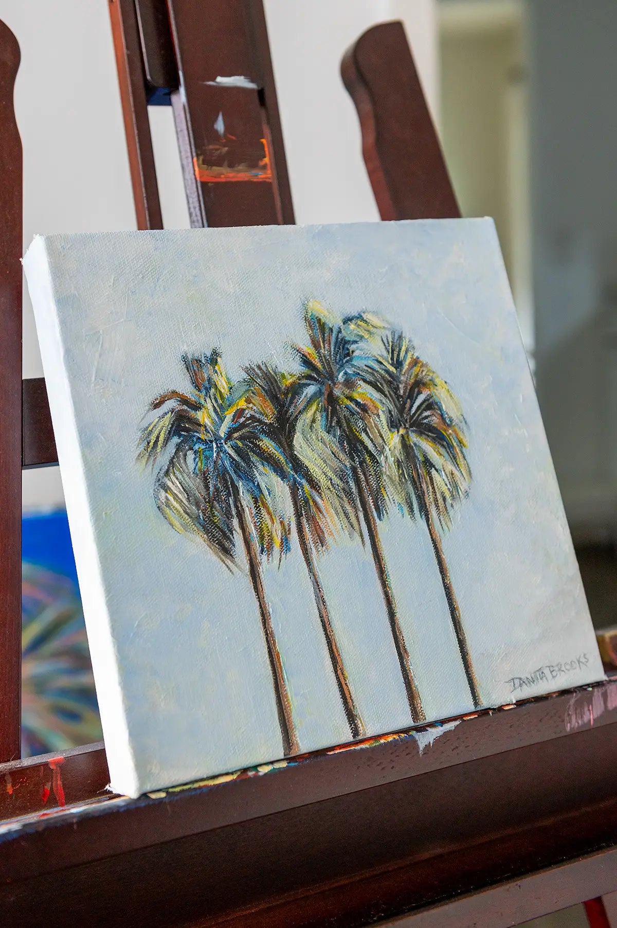 Original coastal landscape painting "Four Palms" by Danita Brooks, shown from an angle to highlight brush texture and depth