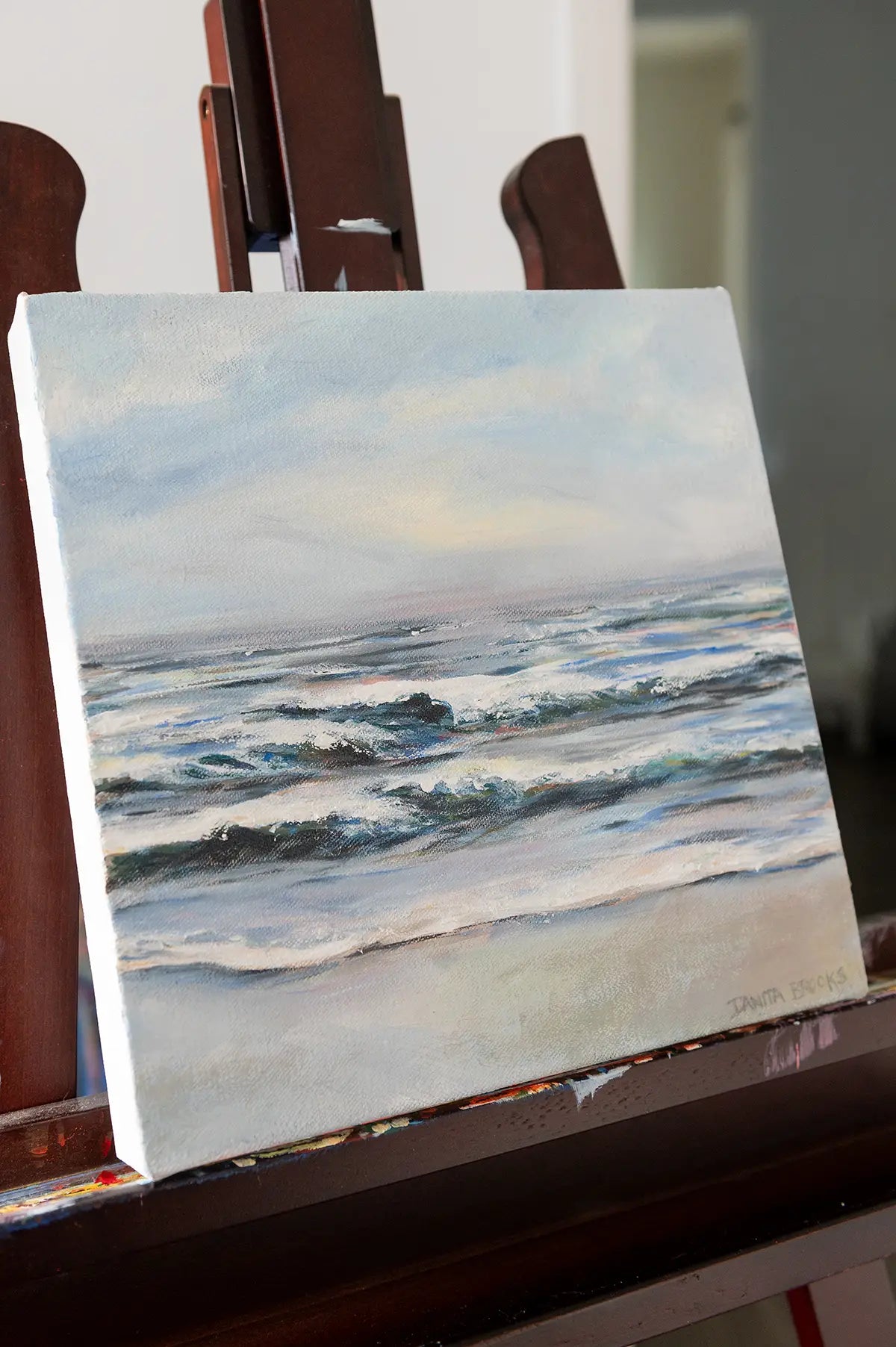 Side view of coastal oil painting "Fresh Start" showing ocean waves and textured brushwork