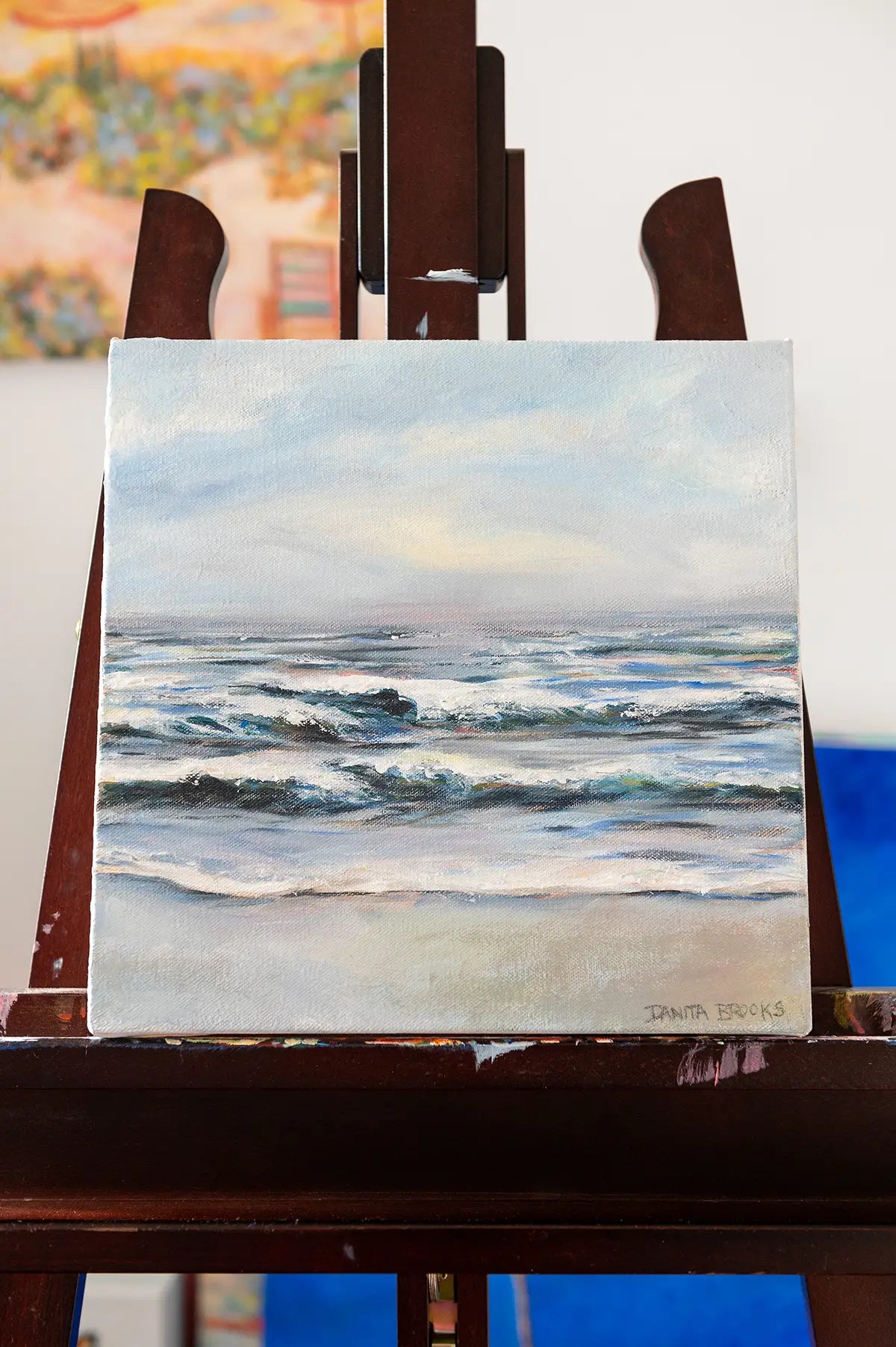 Original seascape oil painting titled "Fresh Start" by Danita Brooks, displayed on an easel in natural light