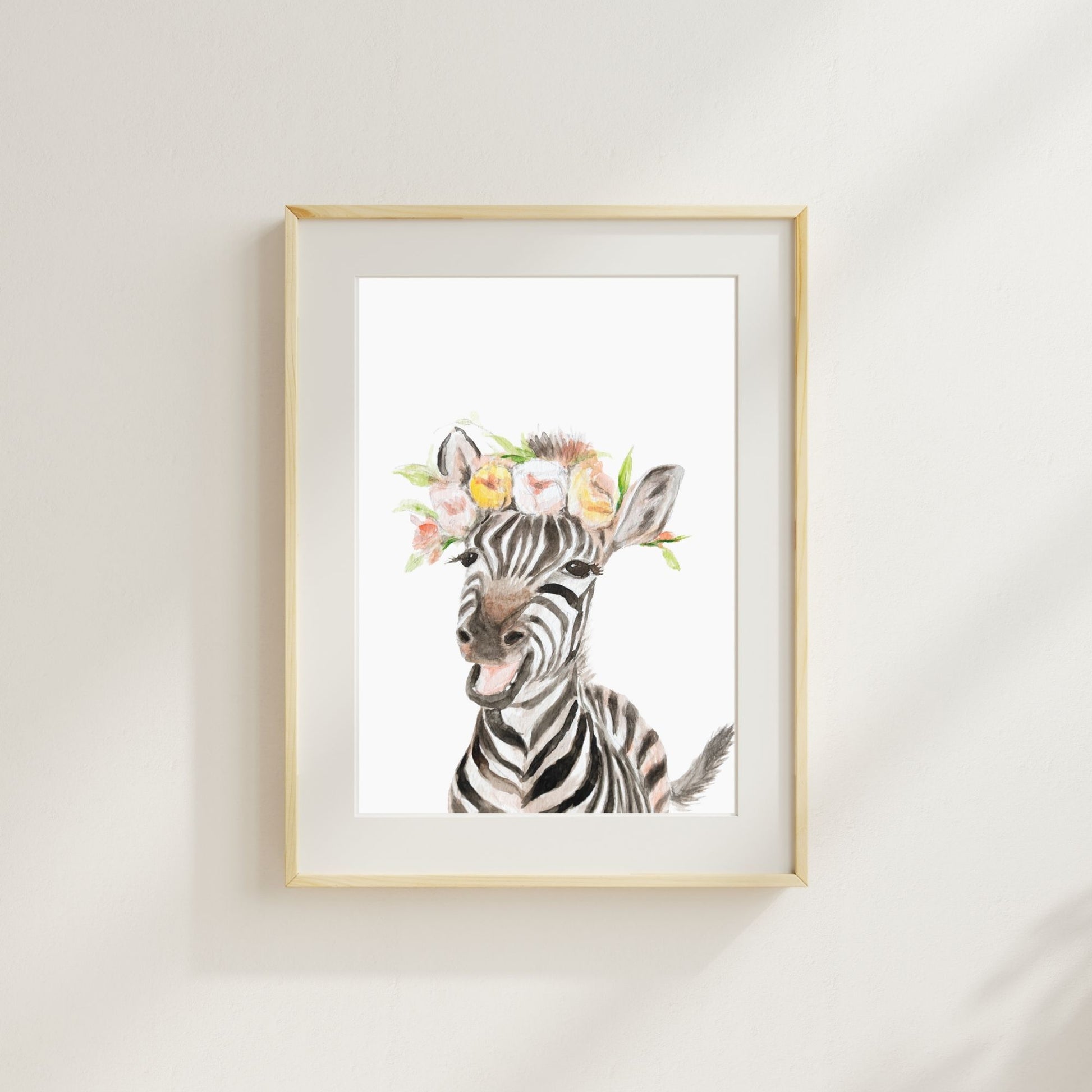 Zebra with pink blossom flower crown watercolor print matted and framed on wall in safari-themed nursery