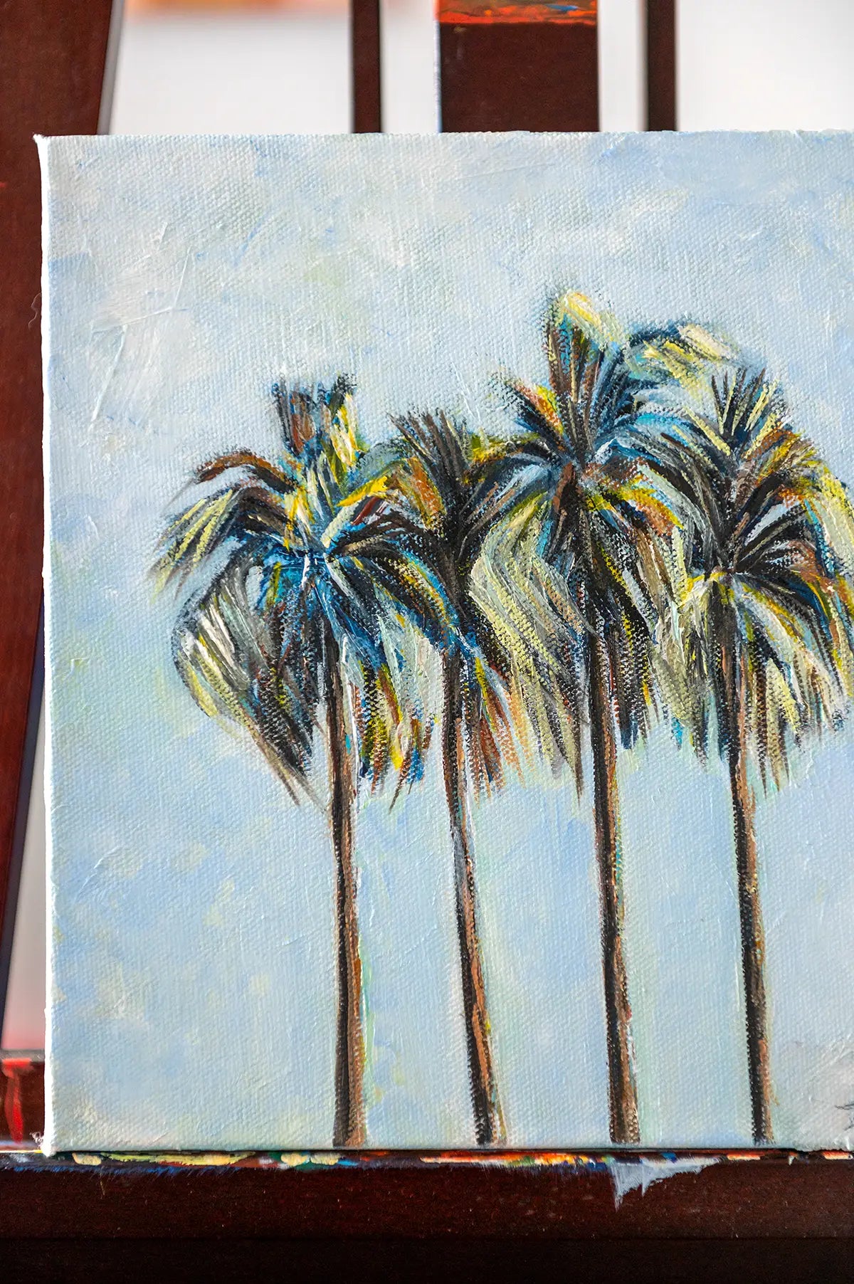 Close-up of palm fronds and brushwork detail in the oil painting "Four Palms" by Danita Brooks