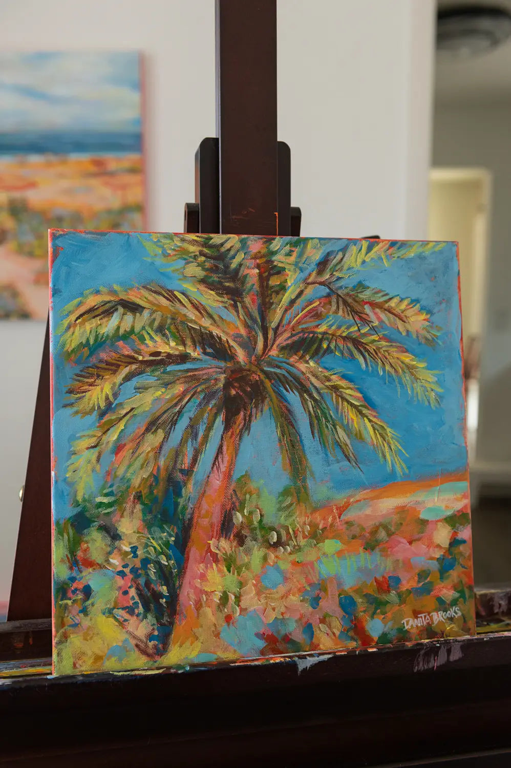Tropical painting "Clear Skies Ahead" by Danita Brooks, angled to show acrylic texture and warm coastal colors