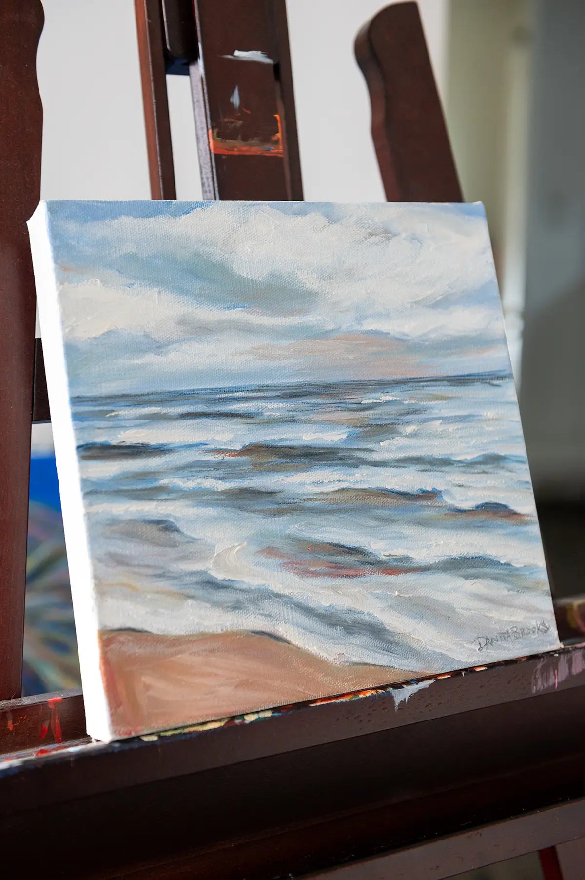 Side view of "Turning Point" coastal painting showing light and ocean reflections in textured brushwork