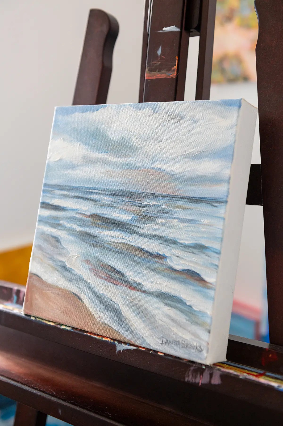 "Turning Point" original oil painting by Danita Brooks, angled to reveal depth and warm coastal tones