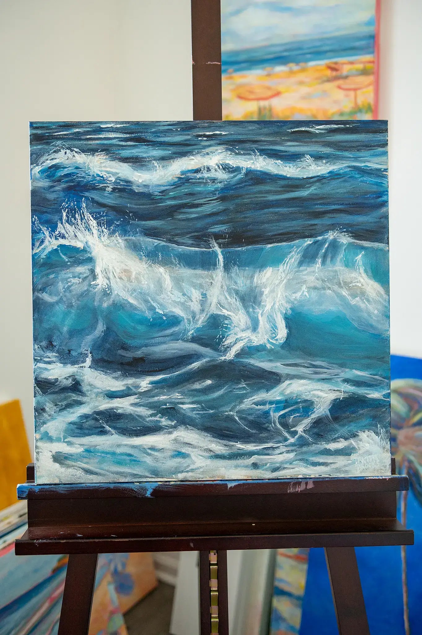 Original ocean wave painting titled "Nanosecond" by Danita Brooks, displayed on a wall with soft natural light