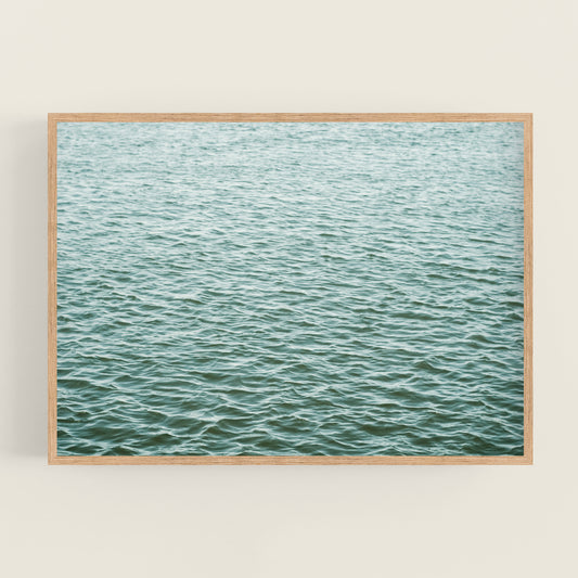 a framed photograph of a body of water