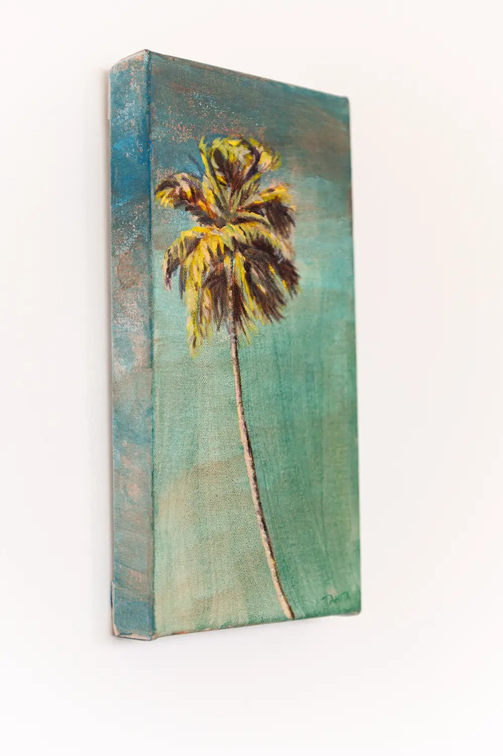 Side view of "The Long Way Home" palm tree painting on a white wall, showing the painted left edge and depth of the canvas.