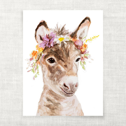 Illustration of a watercolor donkey with a floral headband on a light gray background from Danita Brooks Studio