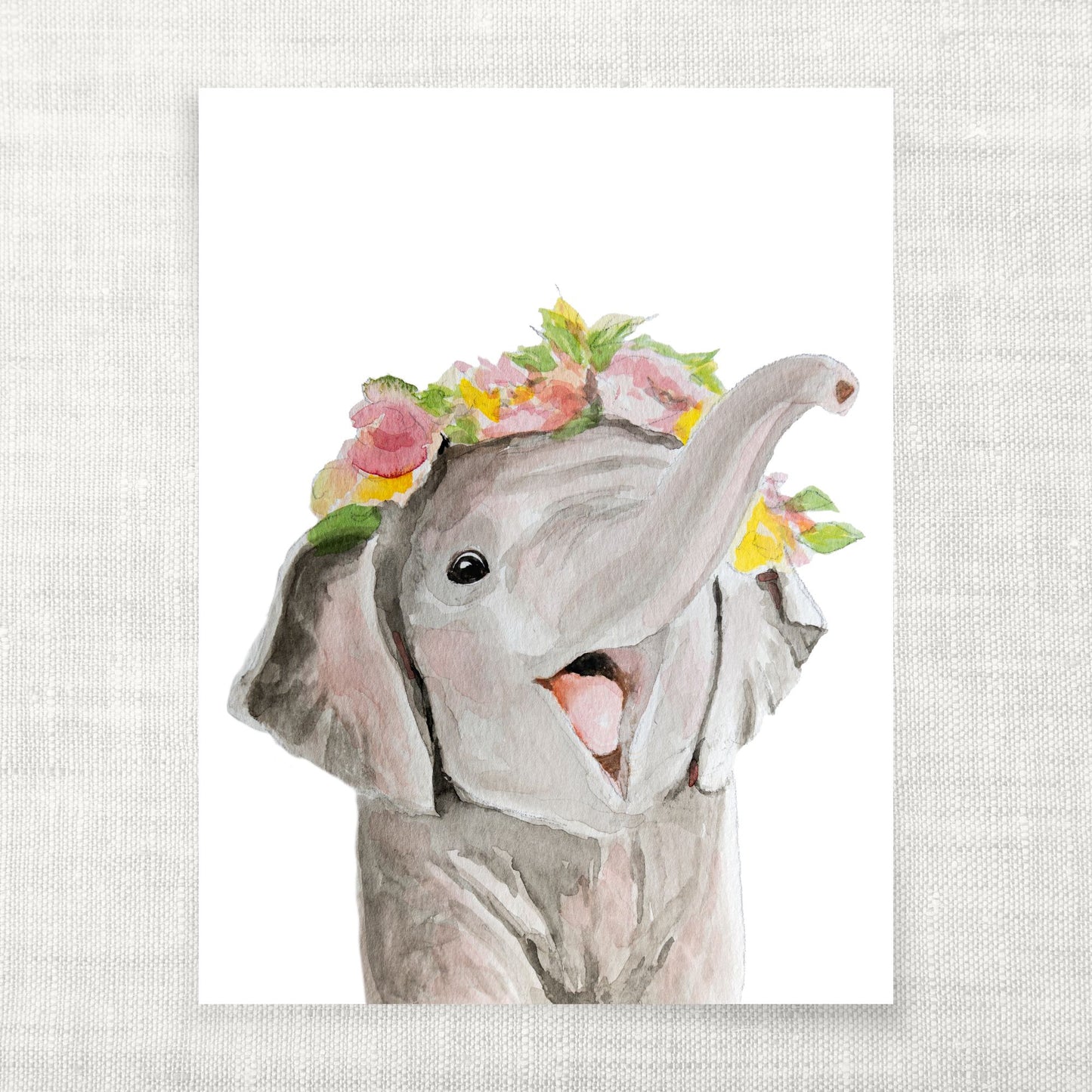 Watercolor painting of an elephant with a floral headband on a textured white background