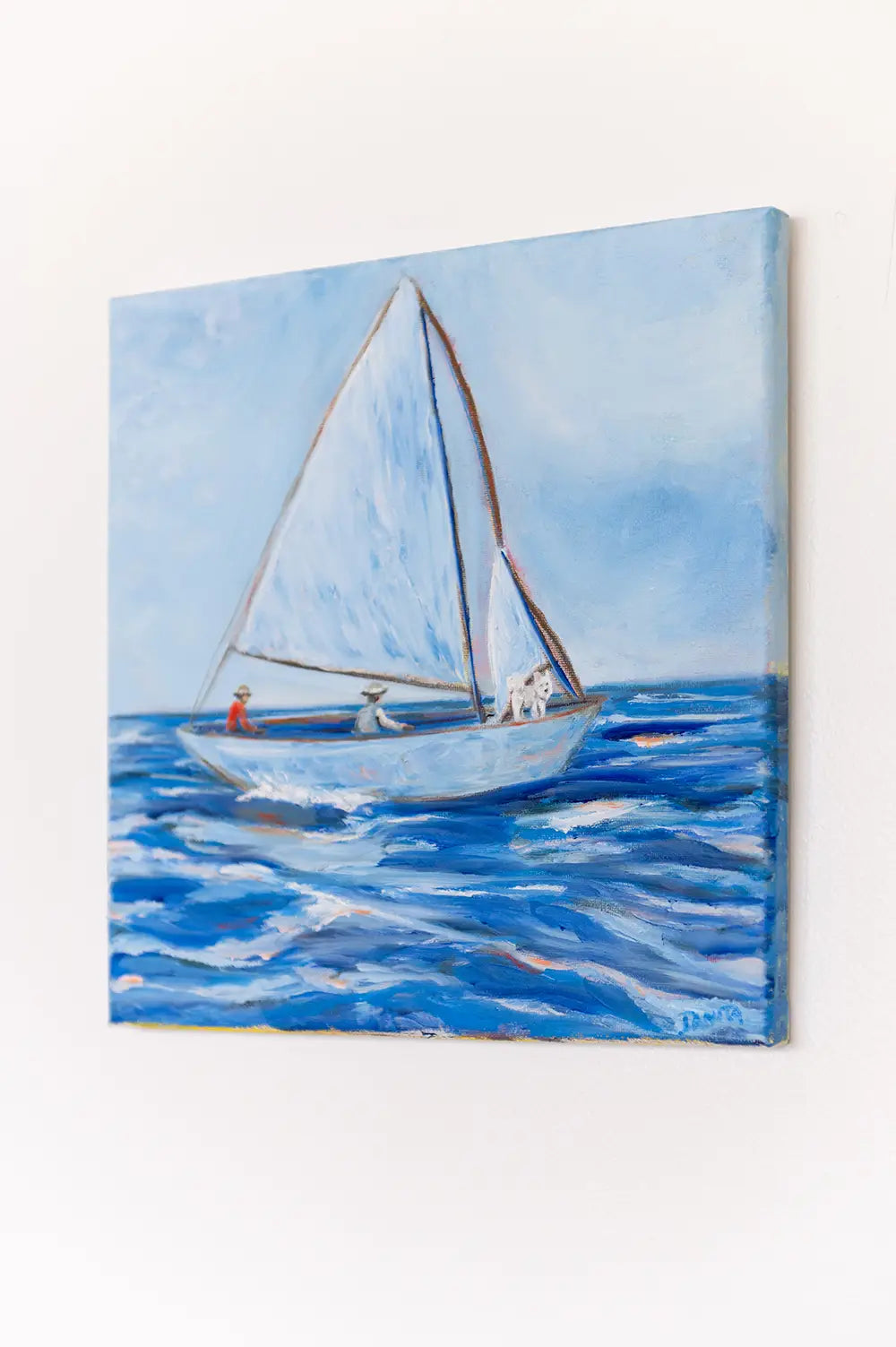 Side view of "First Mate" oil painting hanging on a white wall, showing the canvas depth and the sailboat scene.