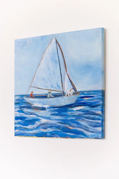 Side view of "First Mate" oil painting hanging on a white wall, showing the canvas depth and the sailboat scene.