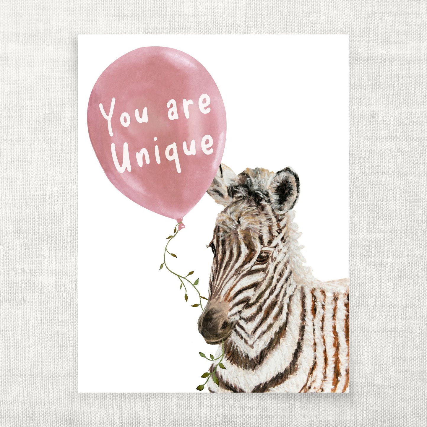 Zebra with a pink balloon that says 'You are Unique' on a light gray background