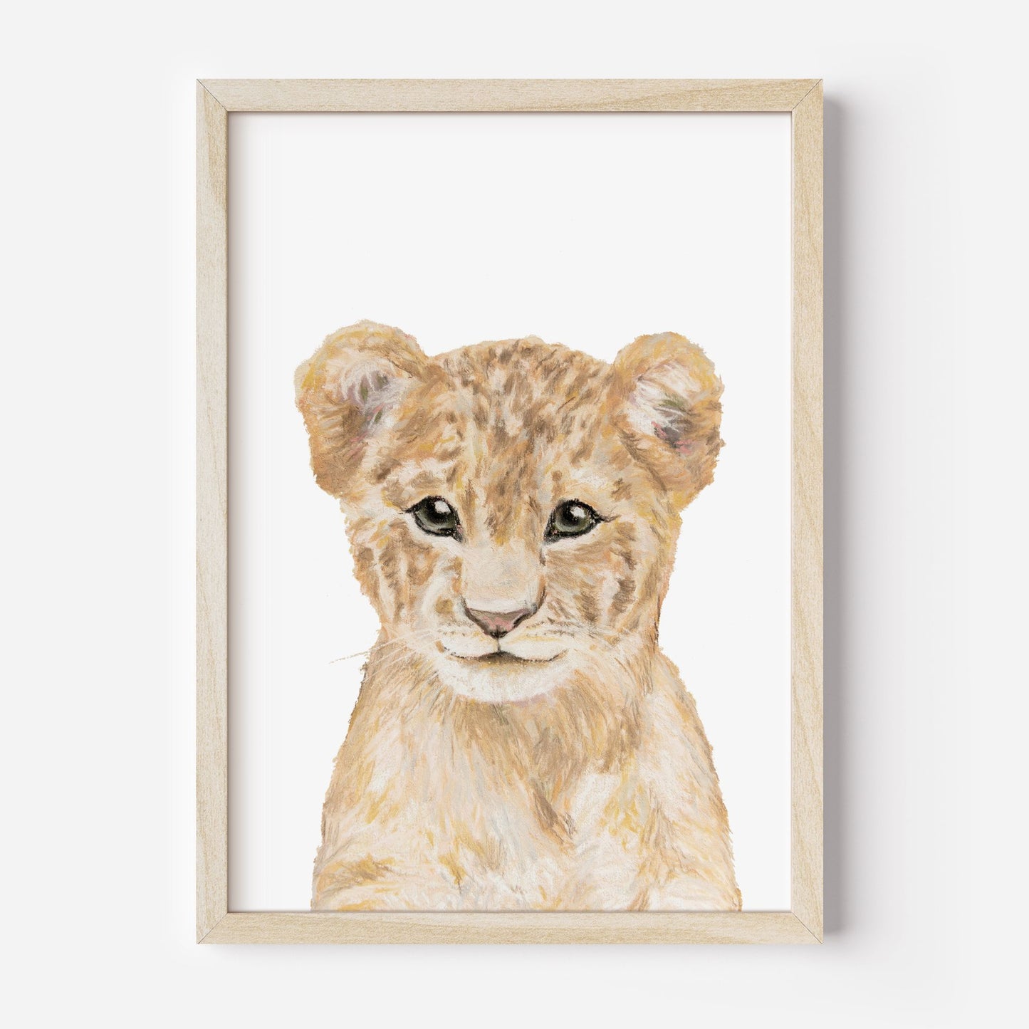 Framed artwork of a lion cub on a white background