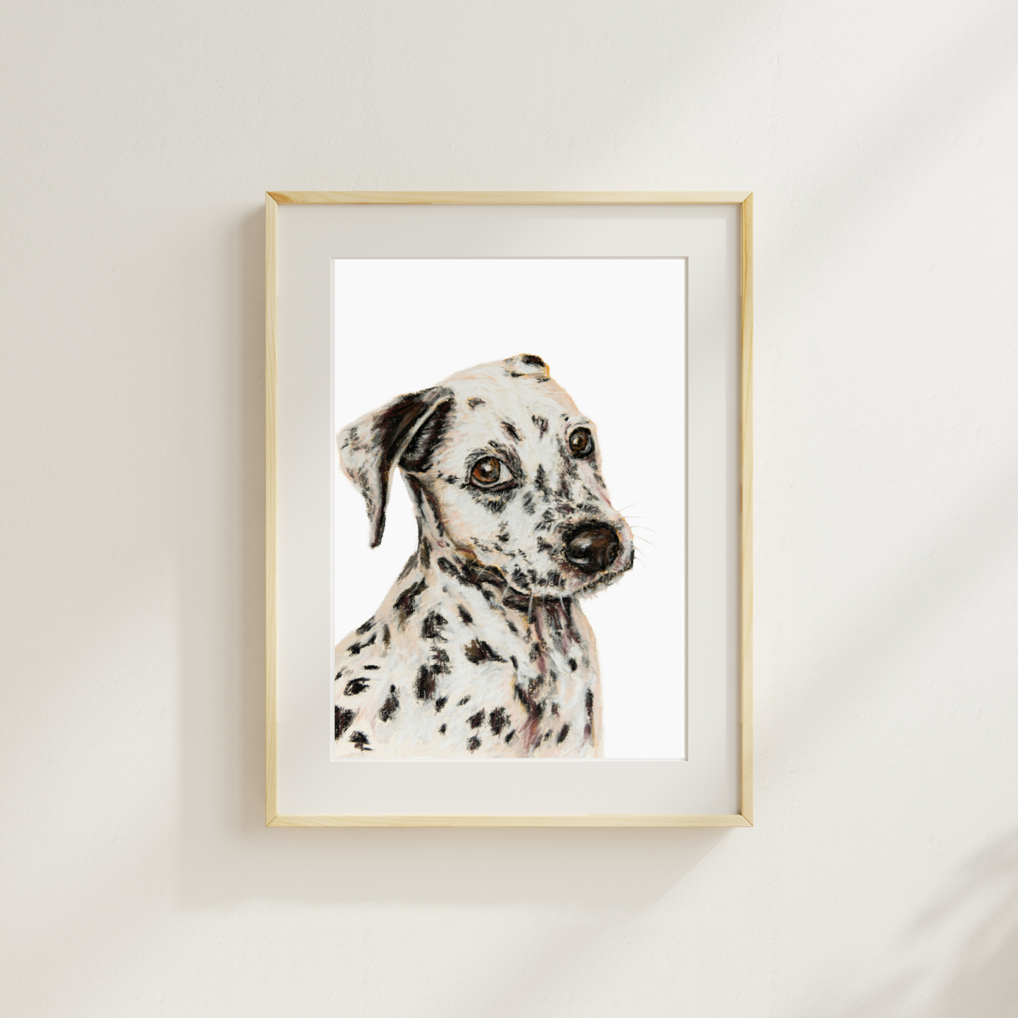 Framed artwork of a Dalmatian dog on a white wall