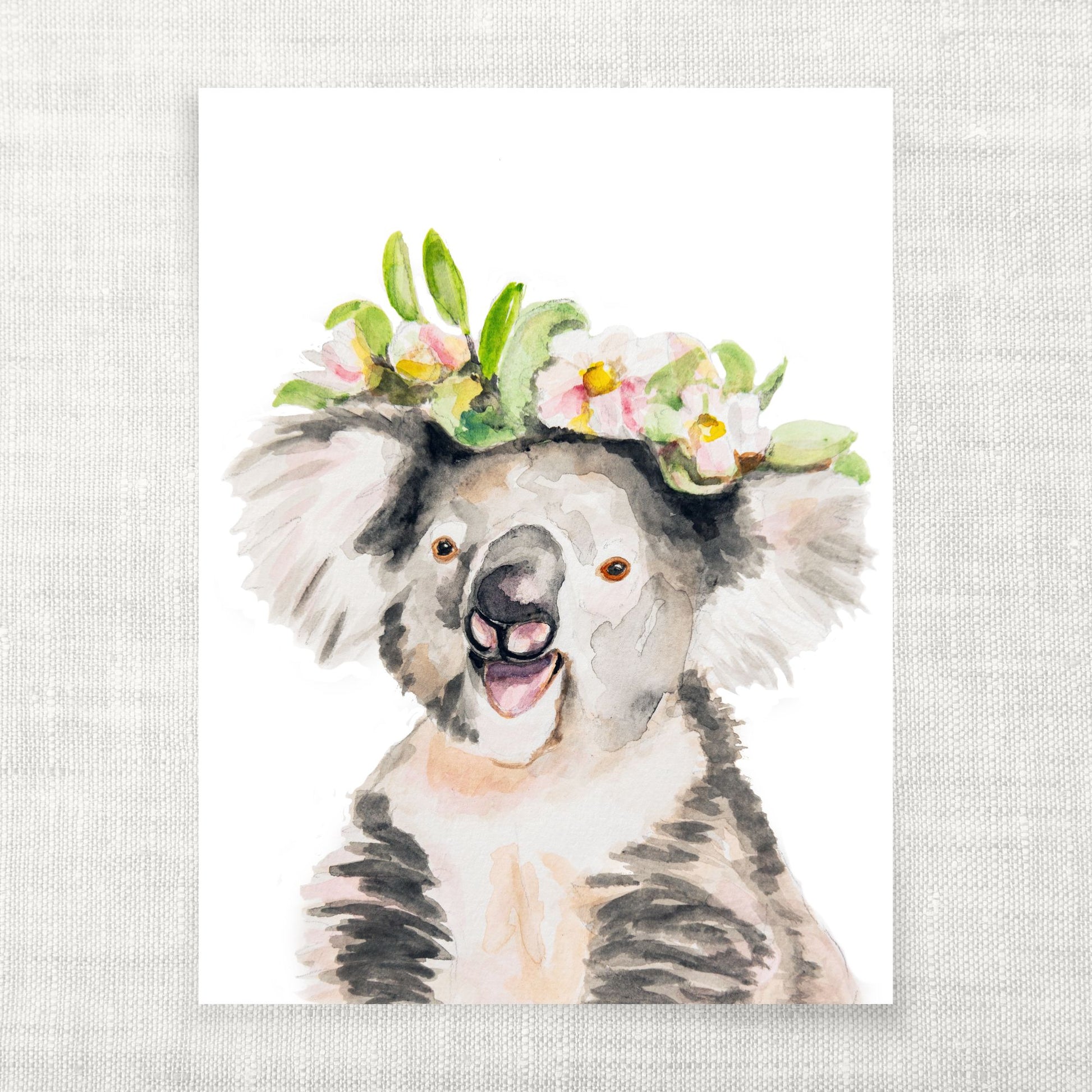 Watercolor illustration of a koala with a floral crown on a light gray background from Danita Brooks Studio