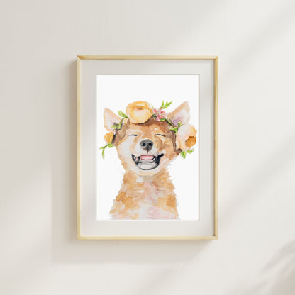 Framed artwork of a watercolor Dingo with floral crown on a white wall from Danita Brooks Studio