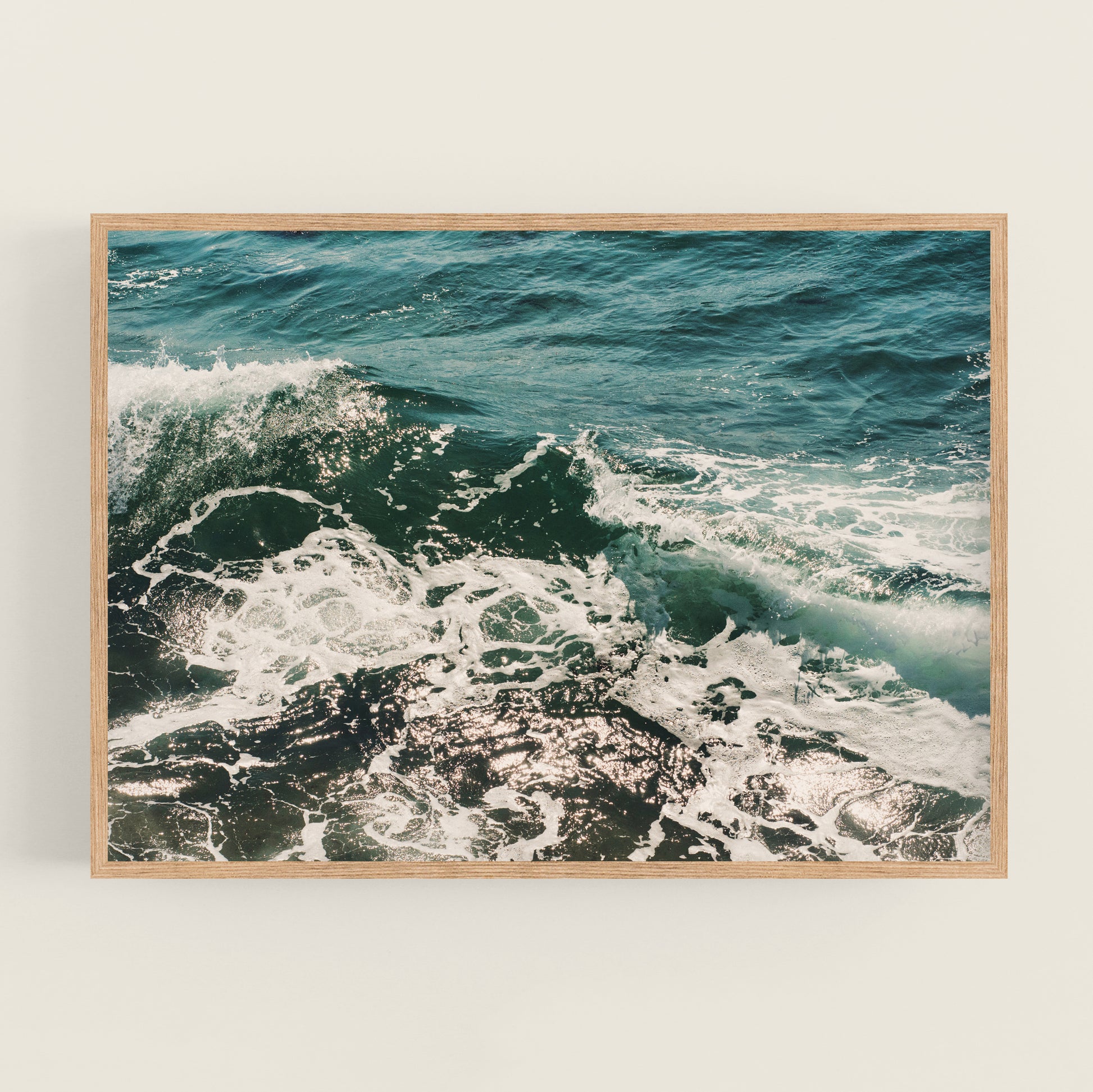 a picture of the ocean is hanging on a wall