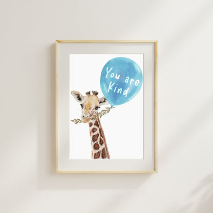 Framed artwork of a giraffe holding a blue balloon with 'You are Kind' text on a light background.