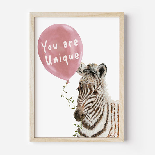 Framed artwork with a zebra holding a pink balloon that says 'You are Unique' on a white background.