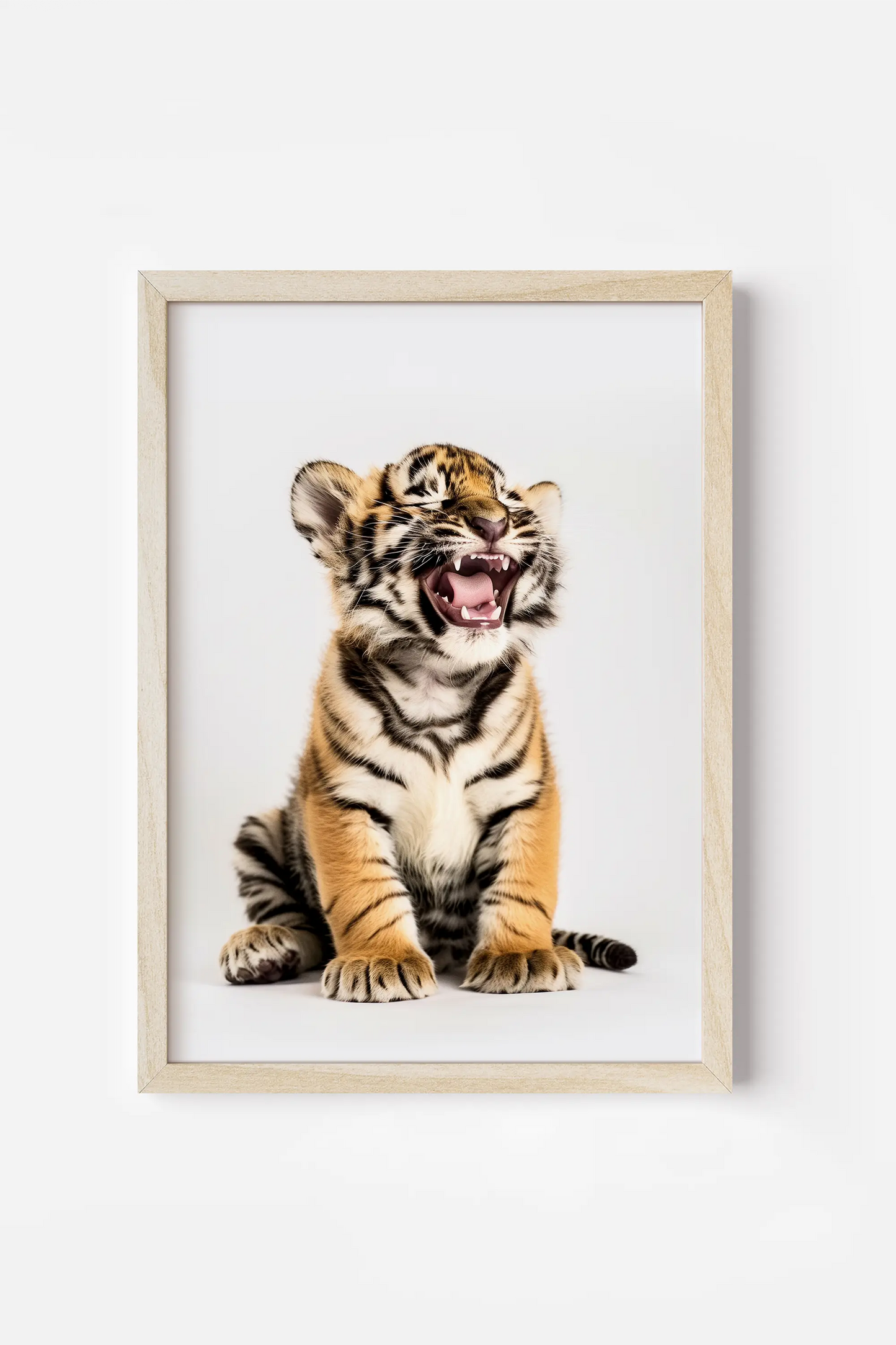 a framed picture of a tiger cub yawning