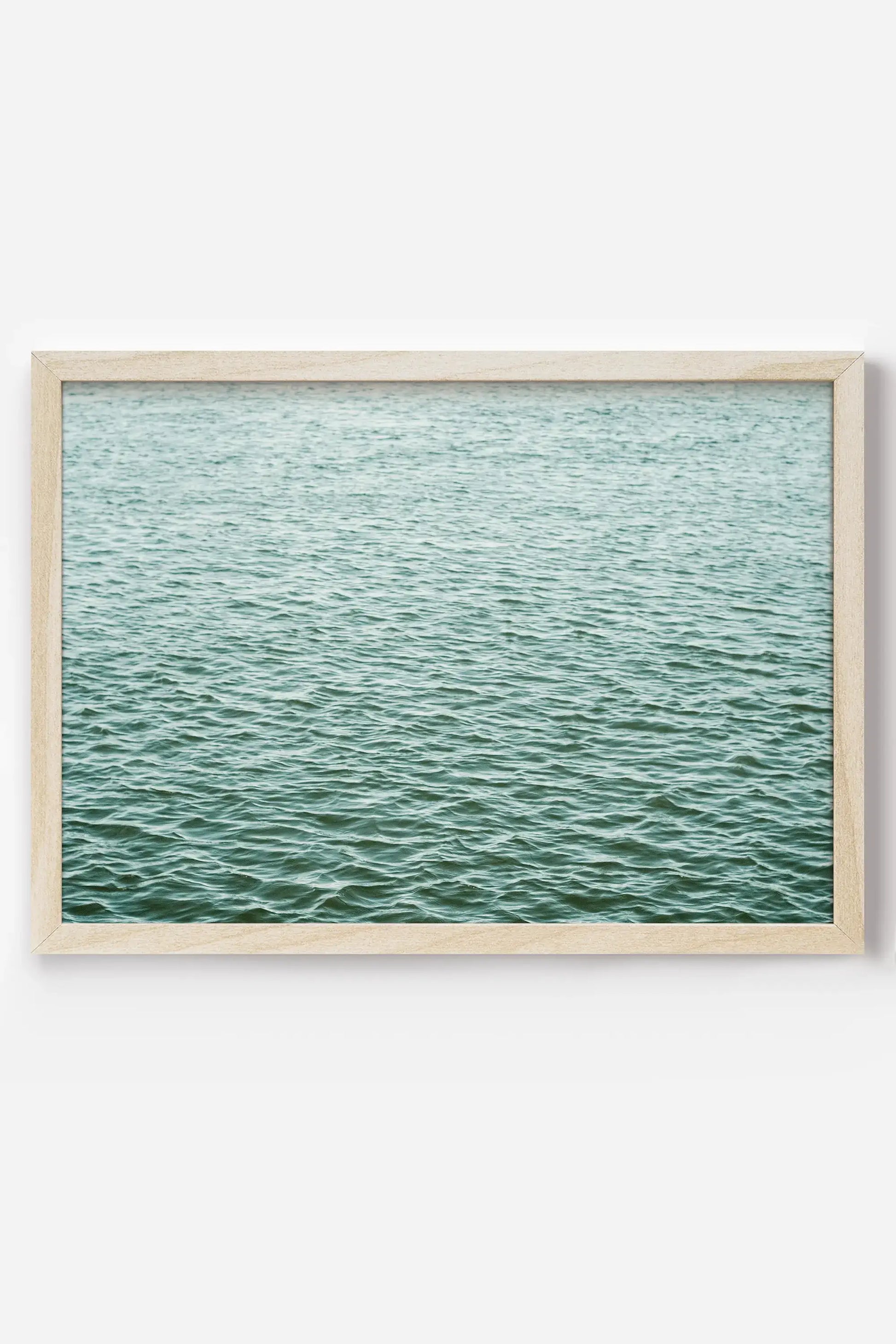 a framed photograph of a body of water