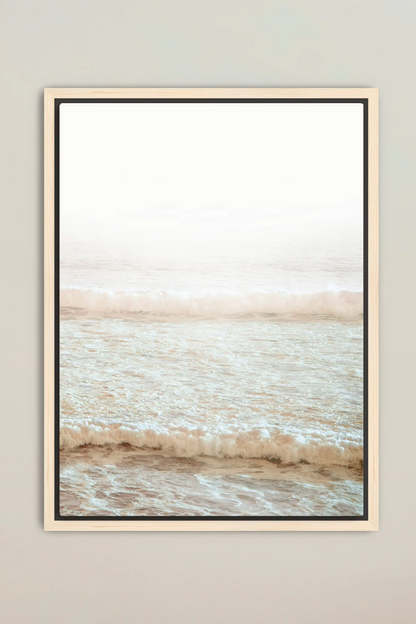 a picture of the ocean with a white frame hanging on a wall