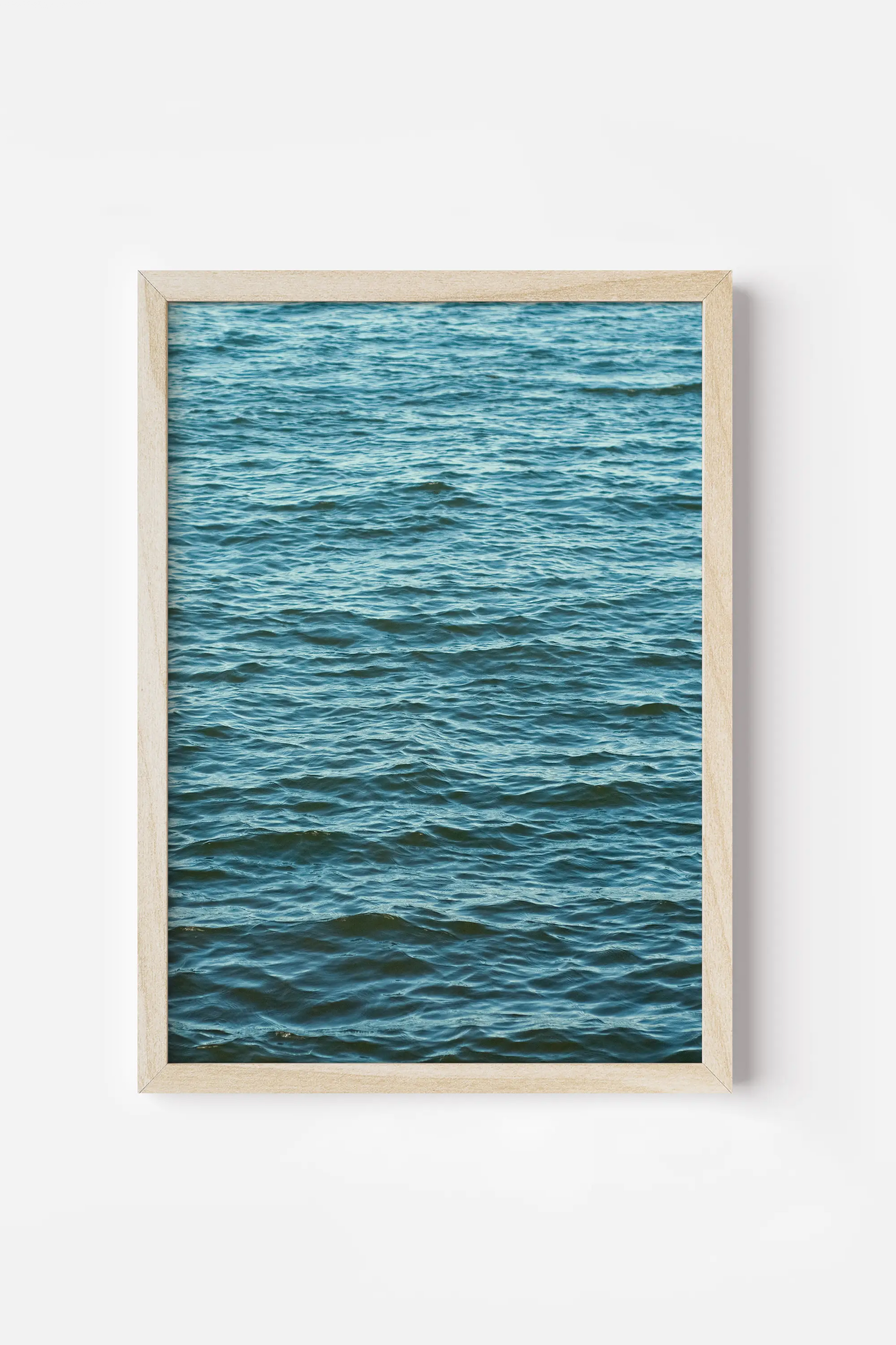 a picture of the ocean is framed in a wooden frame